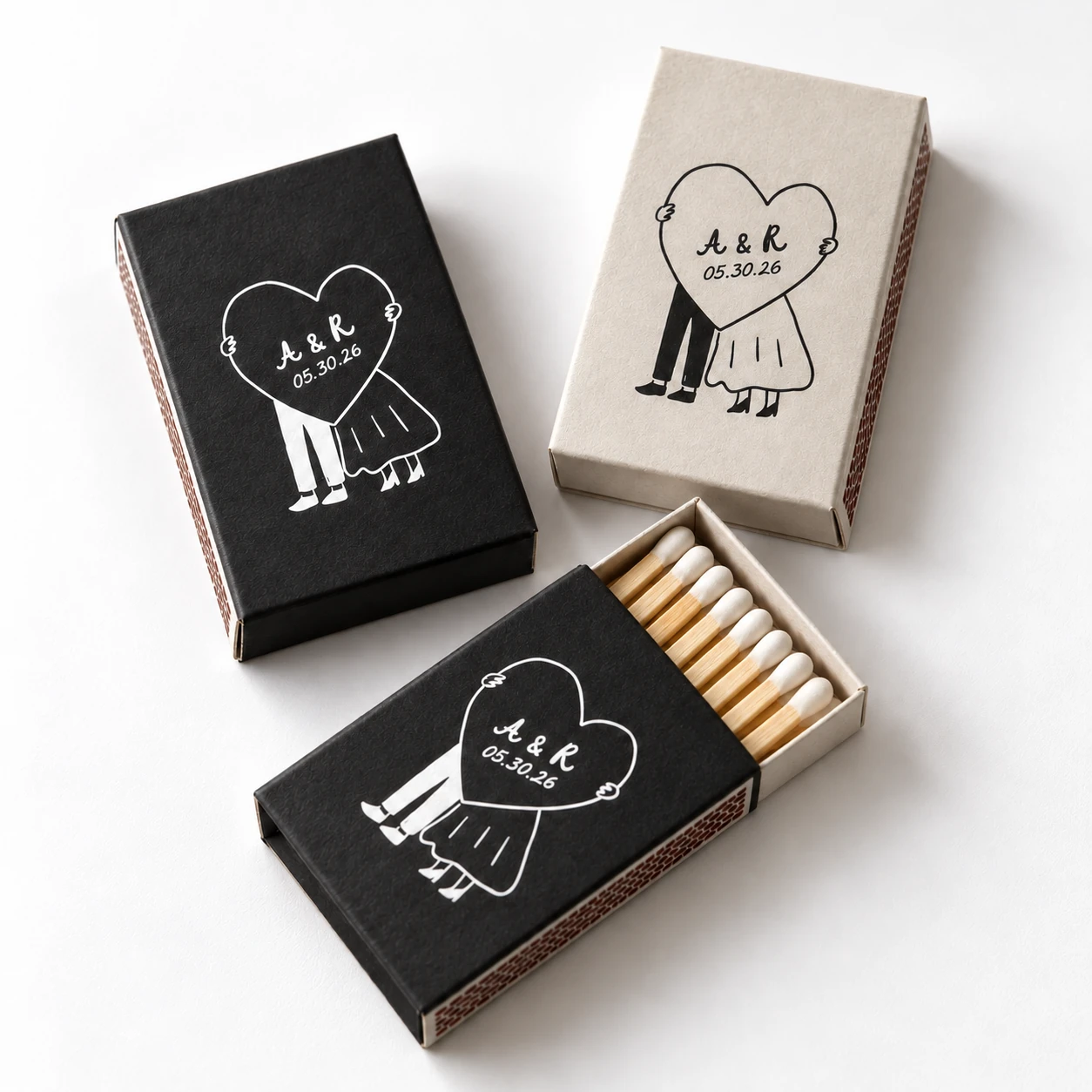 Lexi and Ryan black and ivory matchboxes with a custom couple illustration