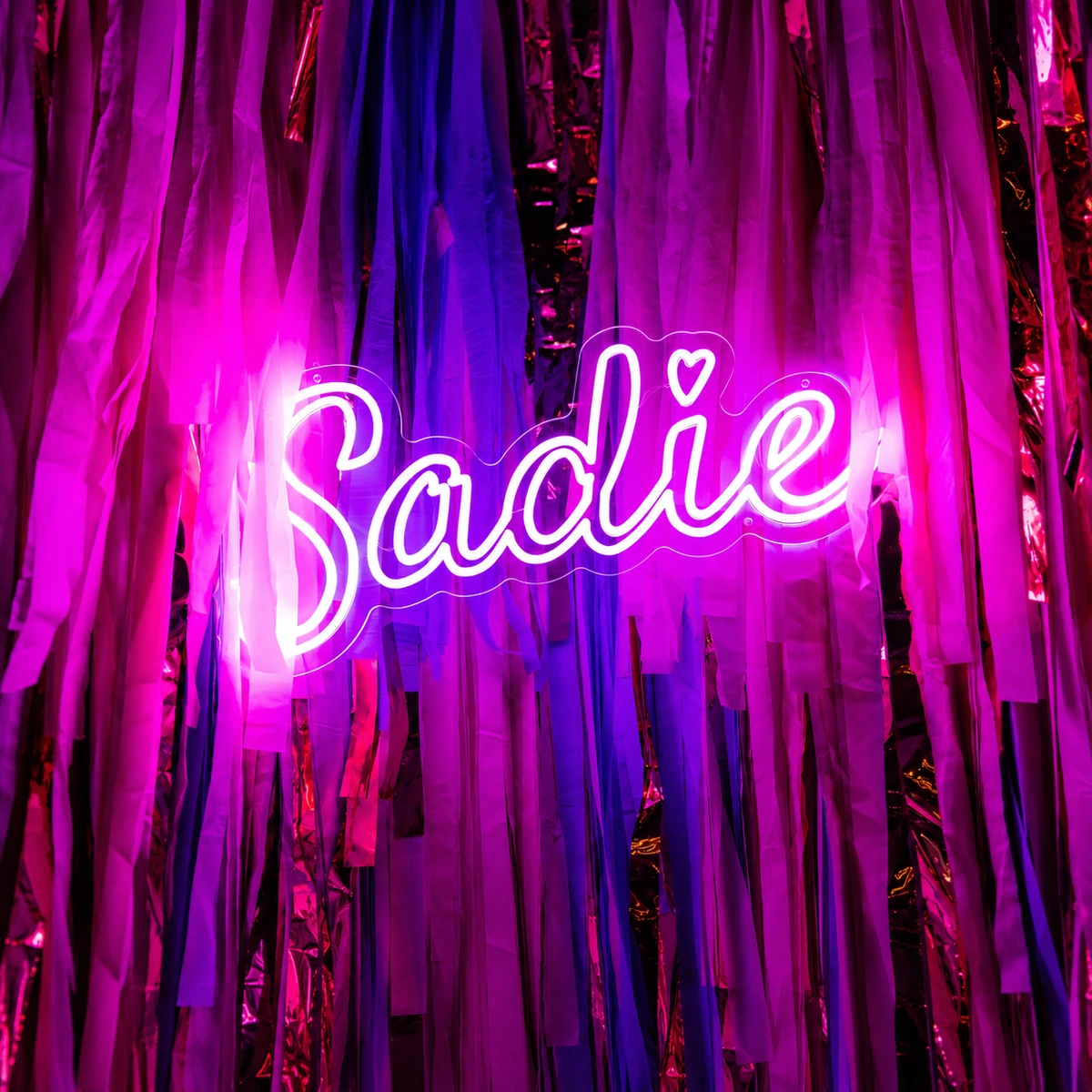 Sadie neon sign on pink foil