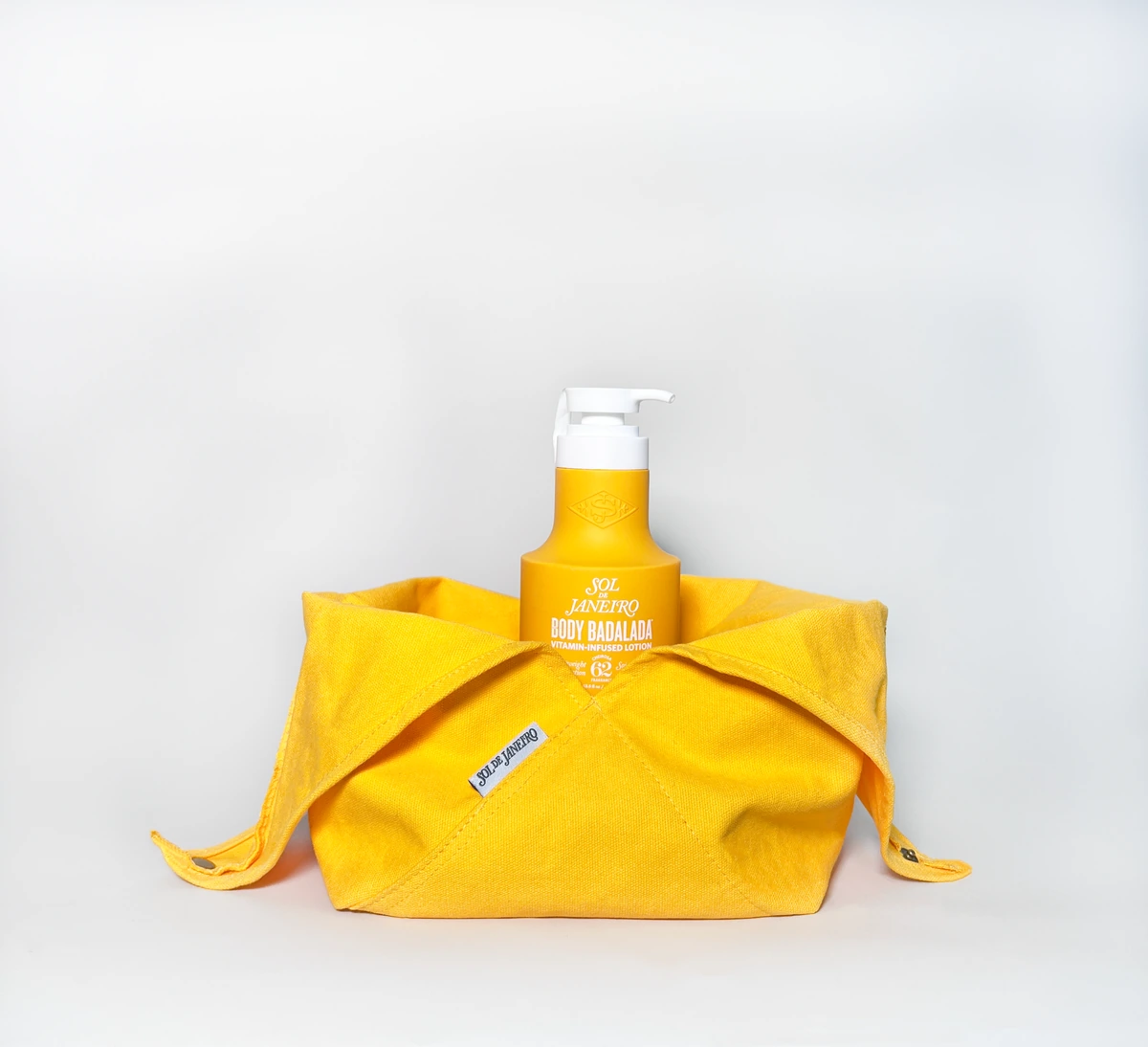 Sol de Janeiro yellow pouch opened around a bottle