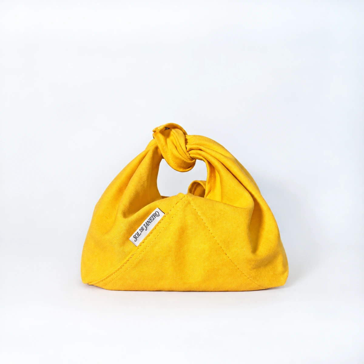 Sol de Janeiro yellow knotted pouch
