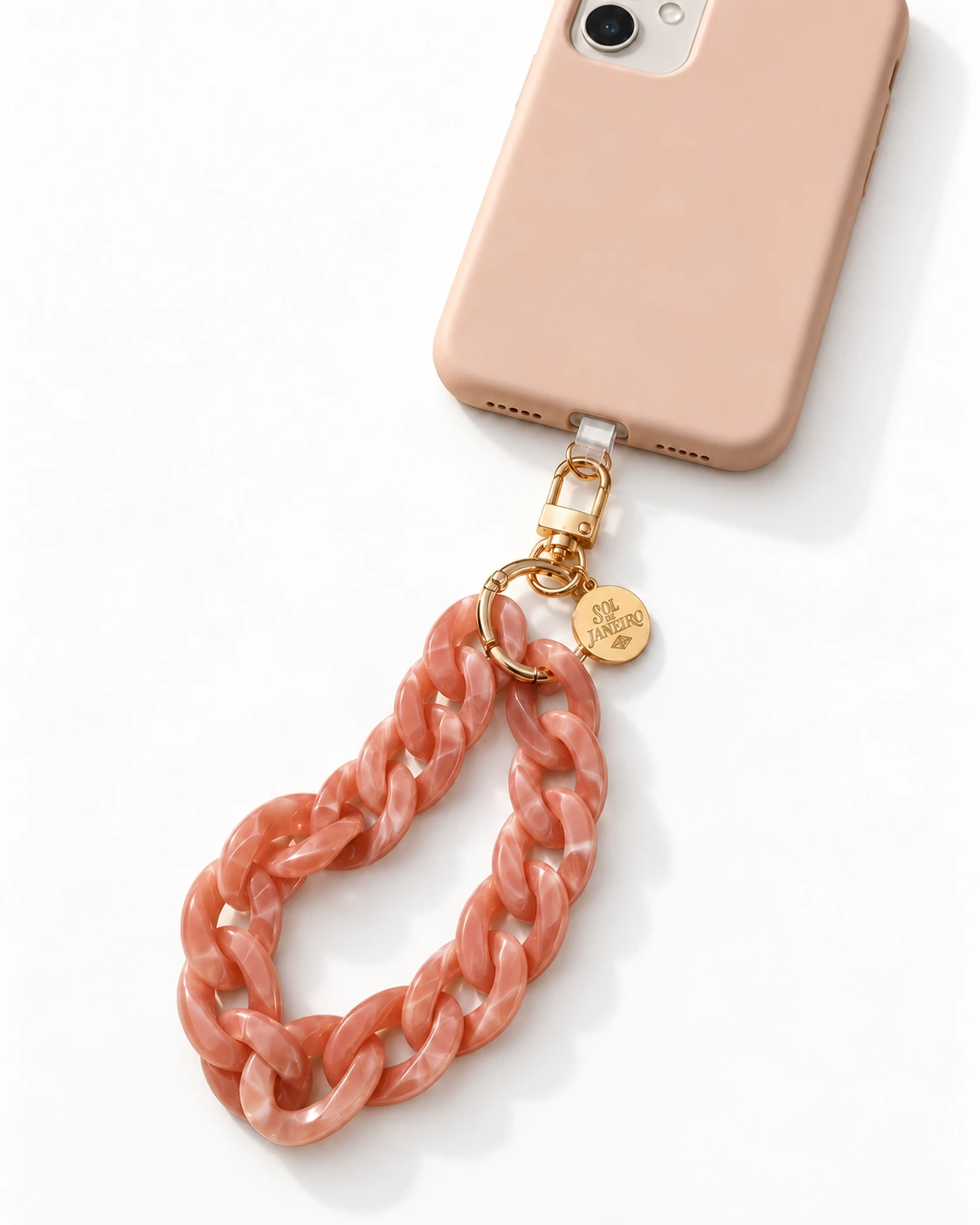 Sol de Janeiro coral wristlet attached to a phone