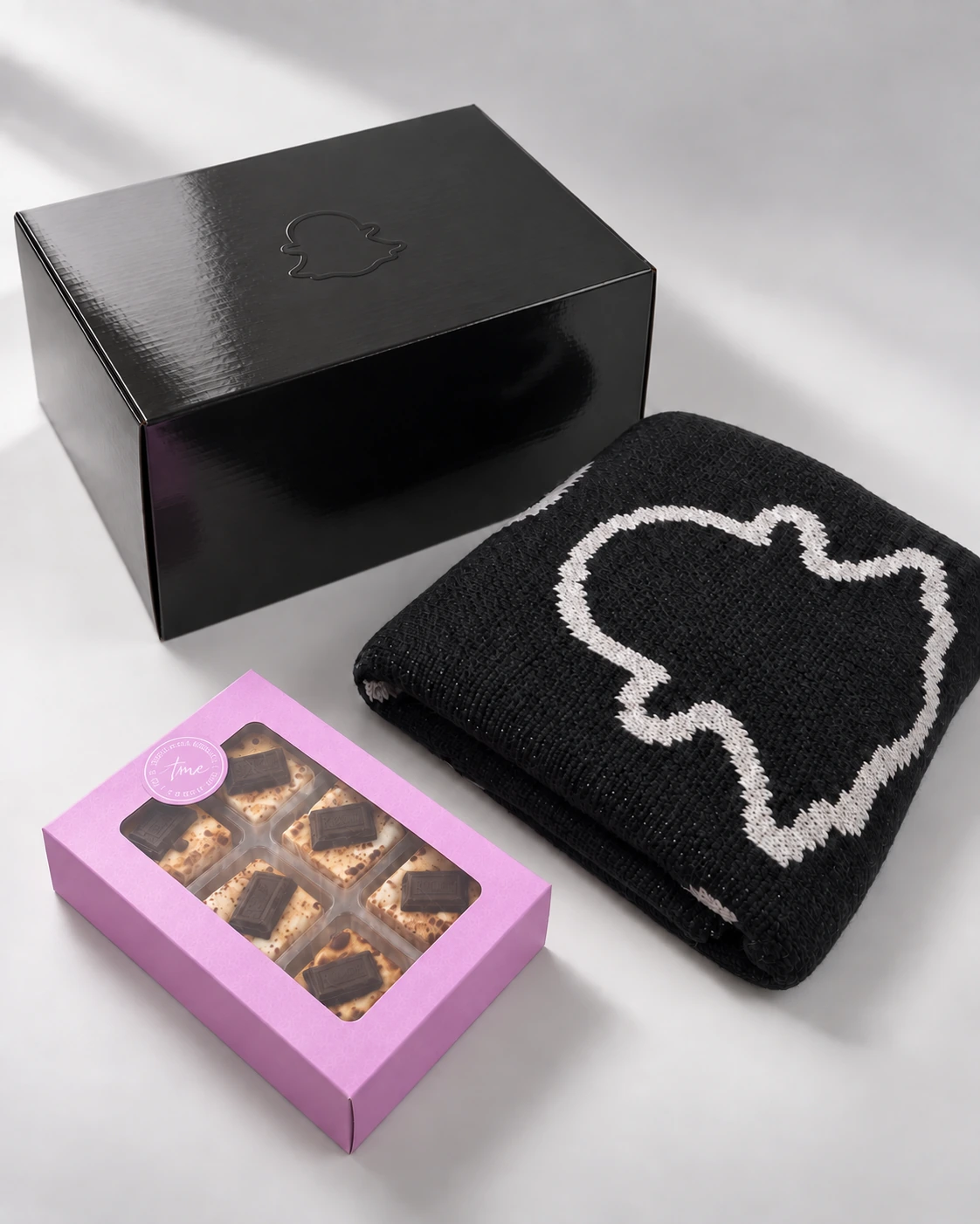 Snapchat closed black gift box with blanket and pink treat packaging