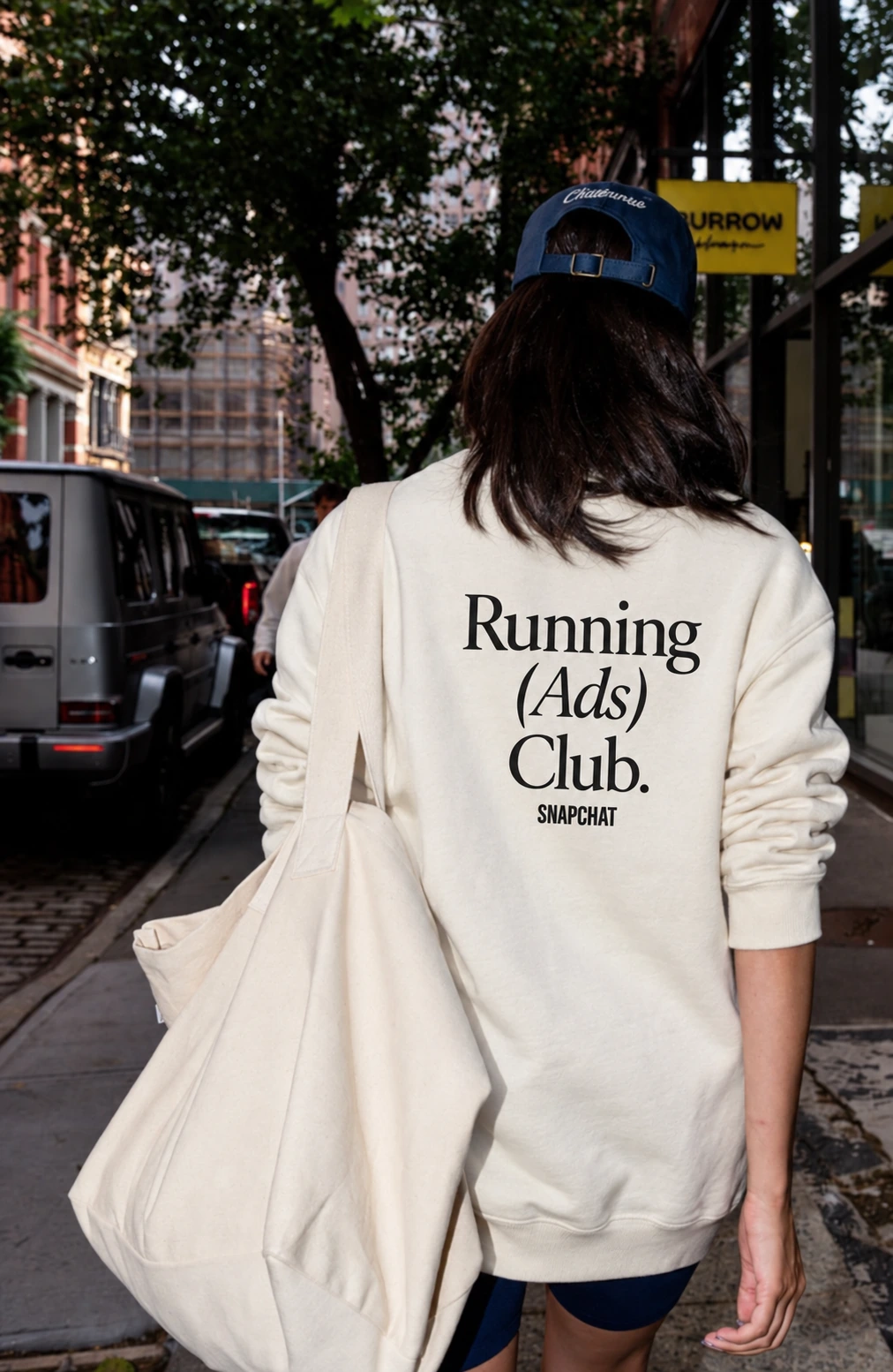 Snapchat Running (Ads) Club. crewneck styled on the street with a canvas tote